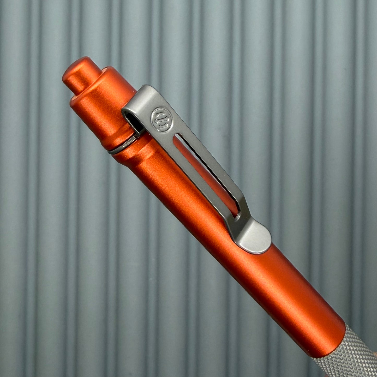 > Spoke Click Model C: Orange Lava Aluminum / Matte Titanium Peak Knurled Grip