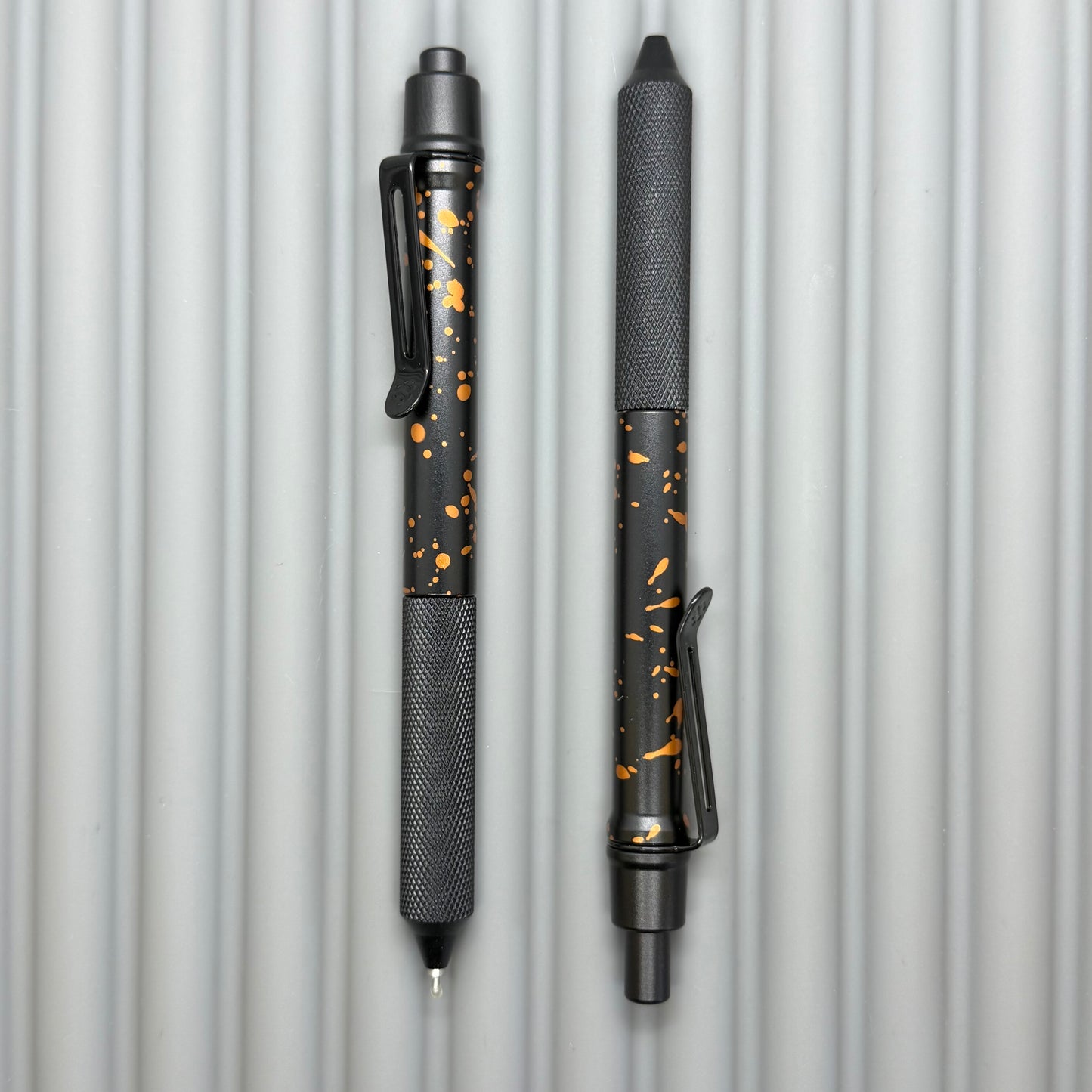 > Spoke Click Model C: Black with Orange Lava Splash, Aluminum / Black Aluminum Peak Knurled Grip
