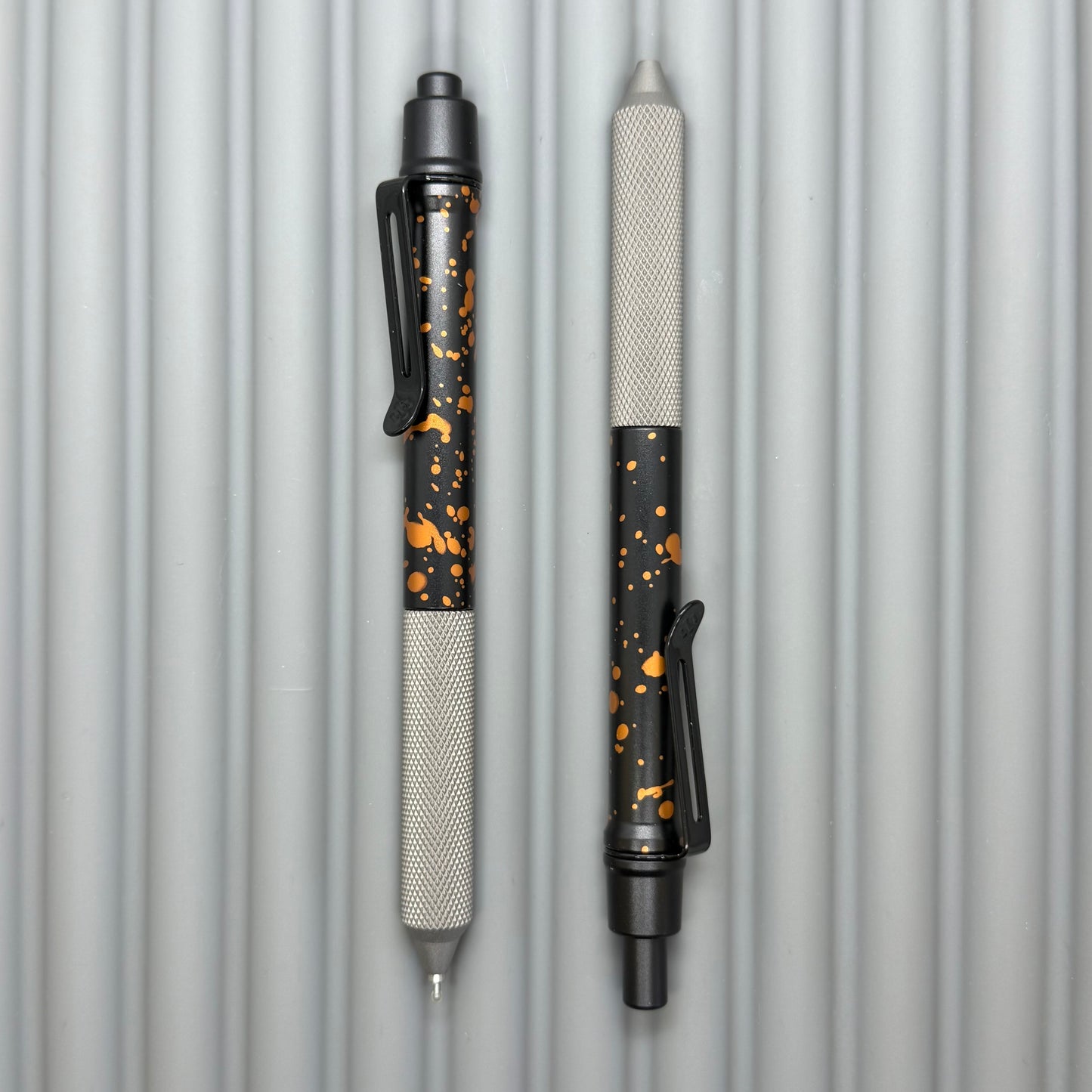 > Spoke Click Model C: Black with Orange Lava Splash, Aluminum / Matte Titanium Peak Knurled Grip