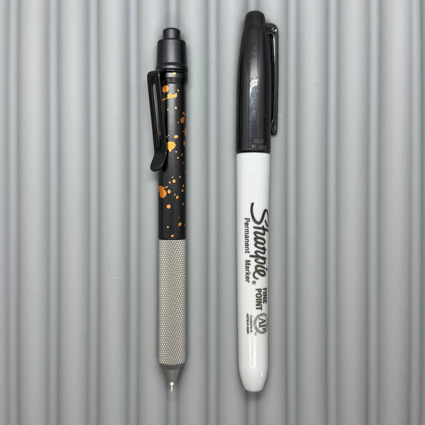 > Spoke Click Model C: Black with Orange Lava Splash, Aluminum / Matte Titanium Peak Knurled Grip
