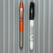 Load image into Gallery viewer, &gt; Spoke Click Model C: Aluminum, Lava Orange / Matte Titanium Grooved Grip